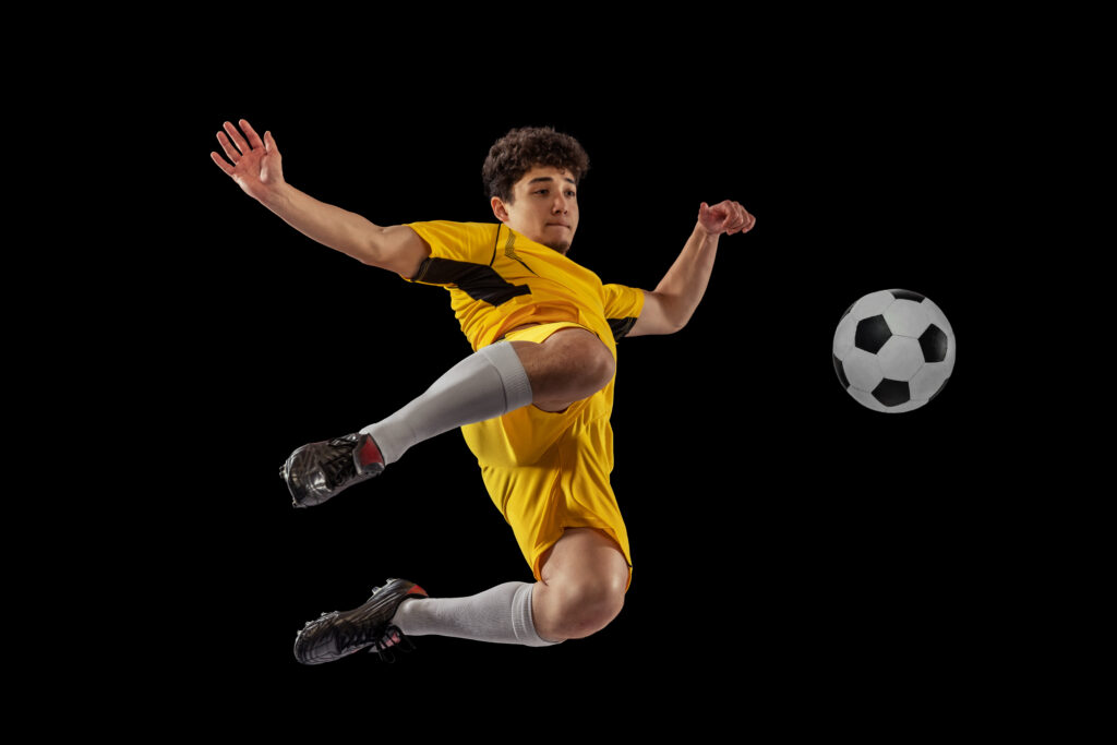 Portrait Young Man Football Playing Motion Training Isolated Black Studio Background Kicking Ball Sample Home Page